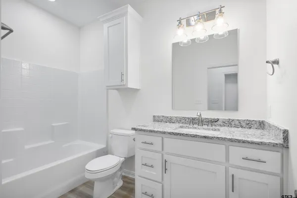 a bathroom with a sink a toilet and bathtub