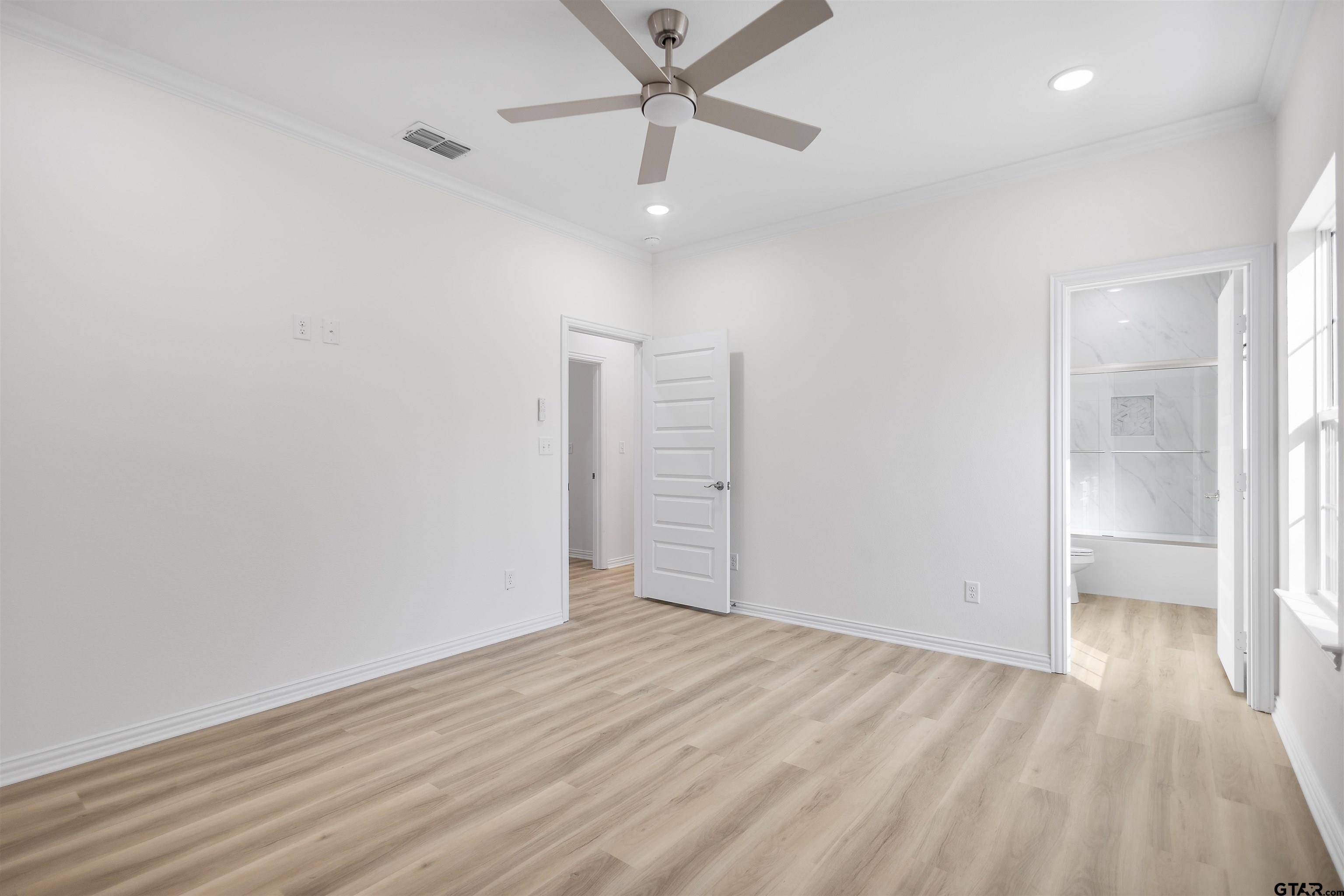 1310 West Claude Street Tyler, TX 75702 - Photo 17 of 27 an empty room with wooden floor and windows