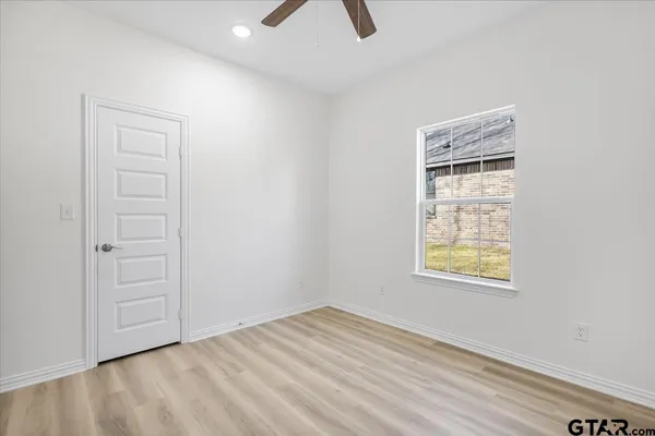 an empty room with windows and closet
