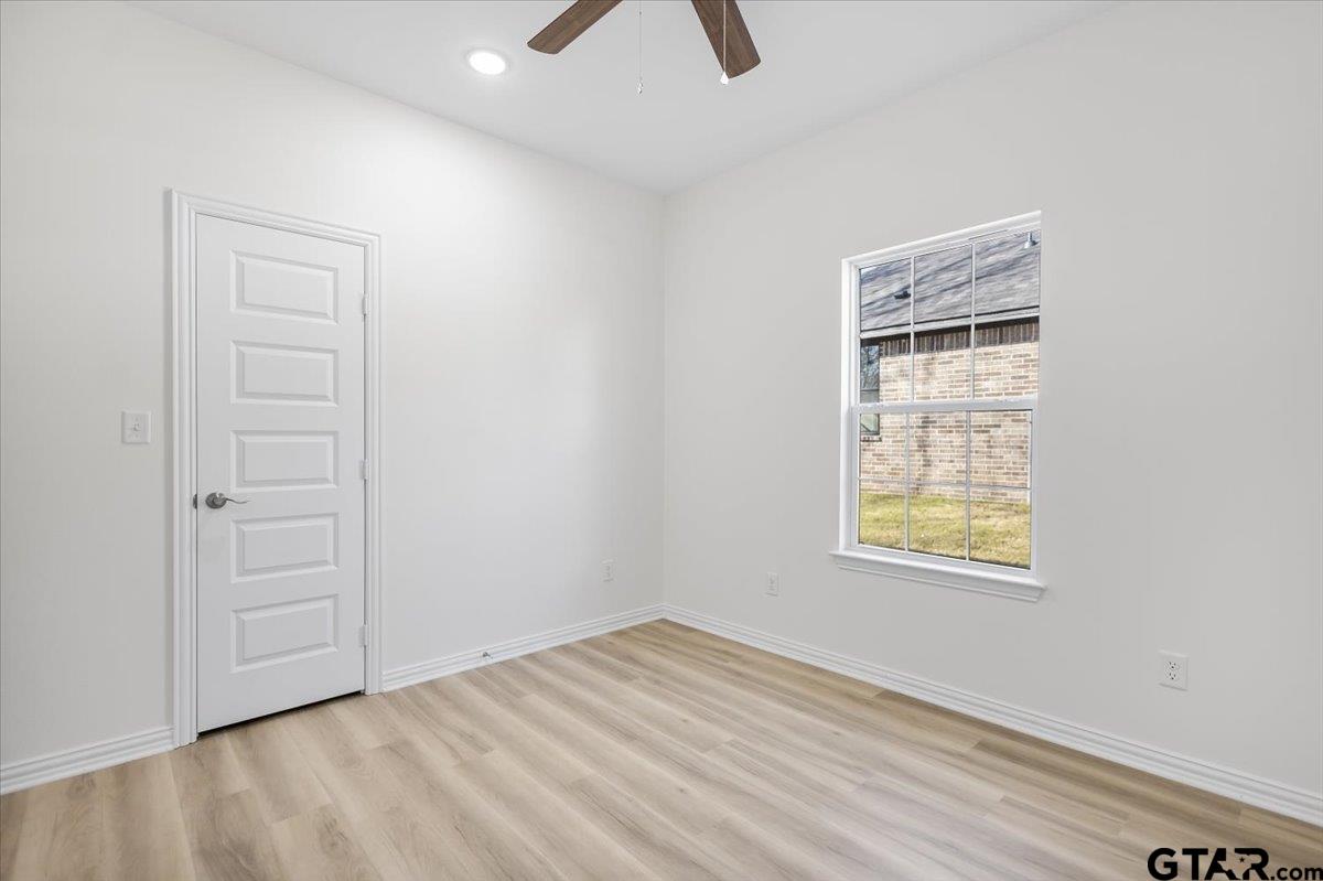 1310 West Claude Street Tyler, TX 75702 - Photo 22 of 27 an empty room with windows and closet