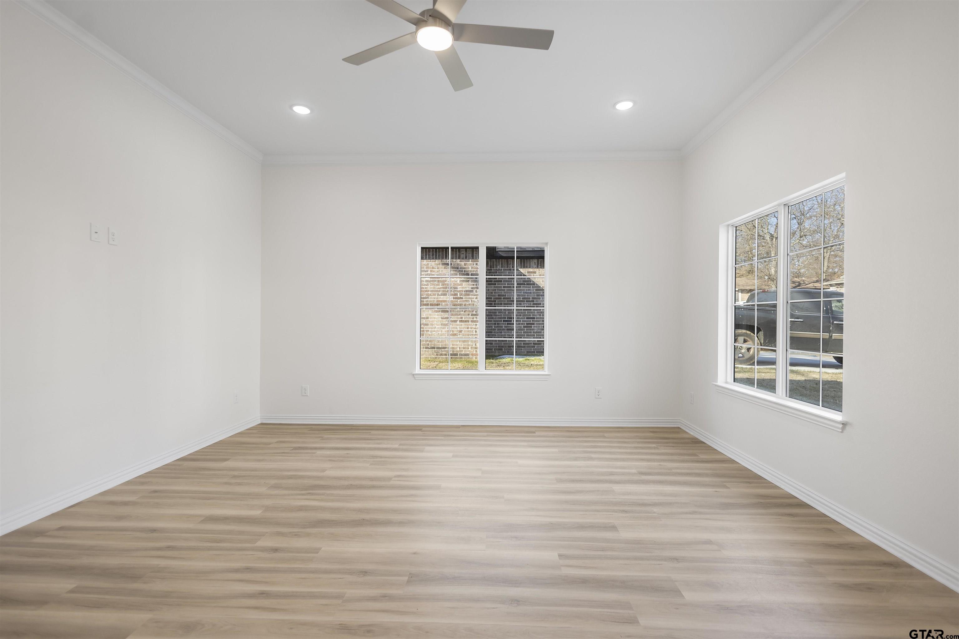 1310 West Claude Street Tyler, TX 75702 - Photo 10 of 27 wooden floor in an empty room with a window