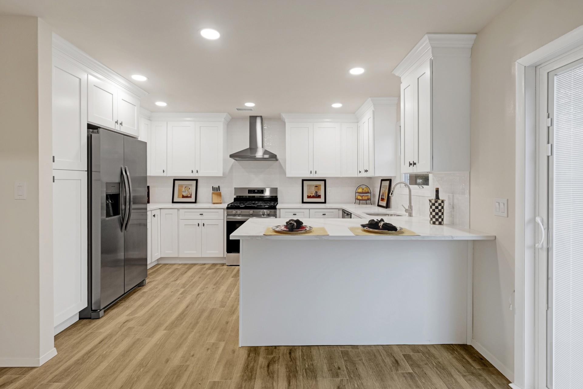 137 Powerhouse Road, Unit 1E Roslyn Heights, NY 11577 - Photo 1 of 1 a kitchen view with stainless steel appliances a refrigerator and a stove top oven