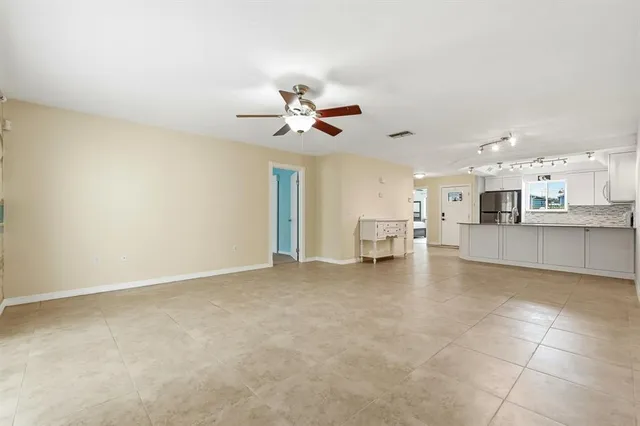 a view of an empty room with a kitchen