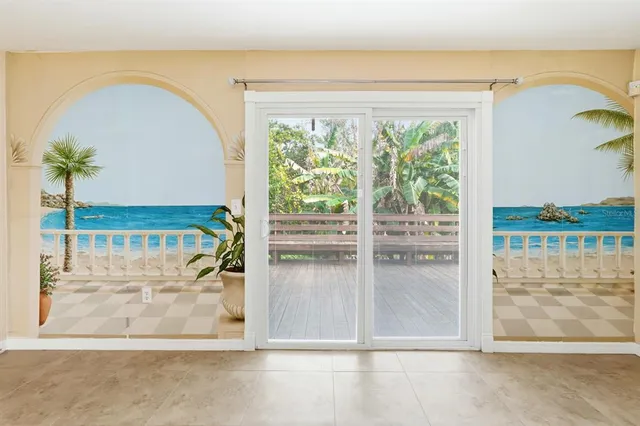 a view of a living room and floor to ceiling window
