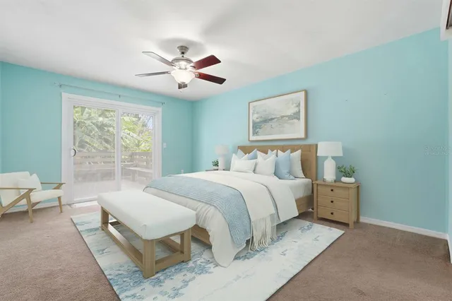 a bedroom with a large bed and a chandelier