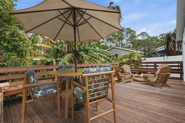a backyard of a house with wooden floor and fence