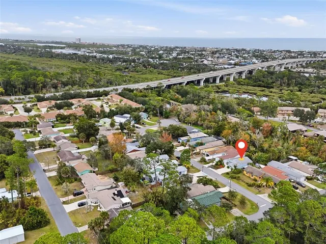 an aerial view of multiple houses with a yard