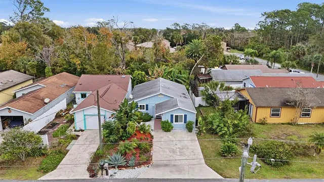 a front view of a house with a yard and potted plants