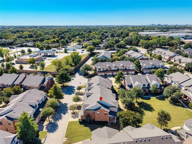 an aerial view of residential houses with outdoor space