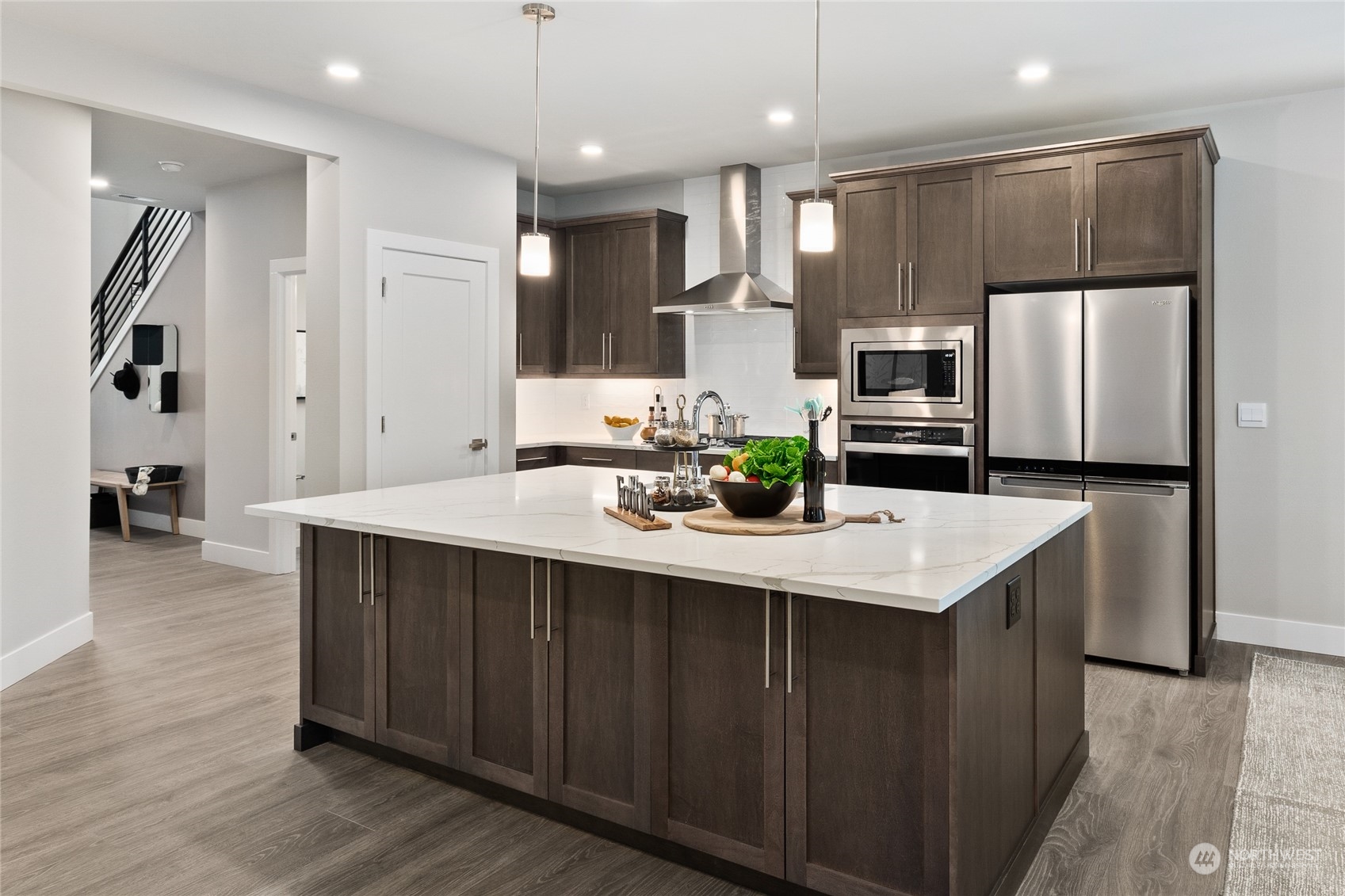 15 177th St S West, Unit IW 15 Bothell, WA 98012 - Photo 5 of 29 a kitchen with kitchen island a sink stainless steel appliances and cabinets