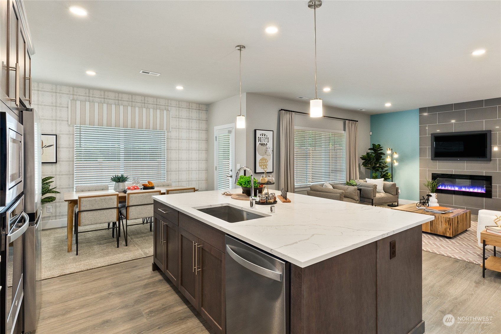 15 177th St S West, Unit IW 15 Bothell, WA 98012 - Photo 10 of 29 a kitchen with stainless steel appliances a stove a sink a microwave a dining table and chairs