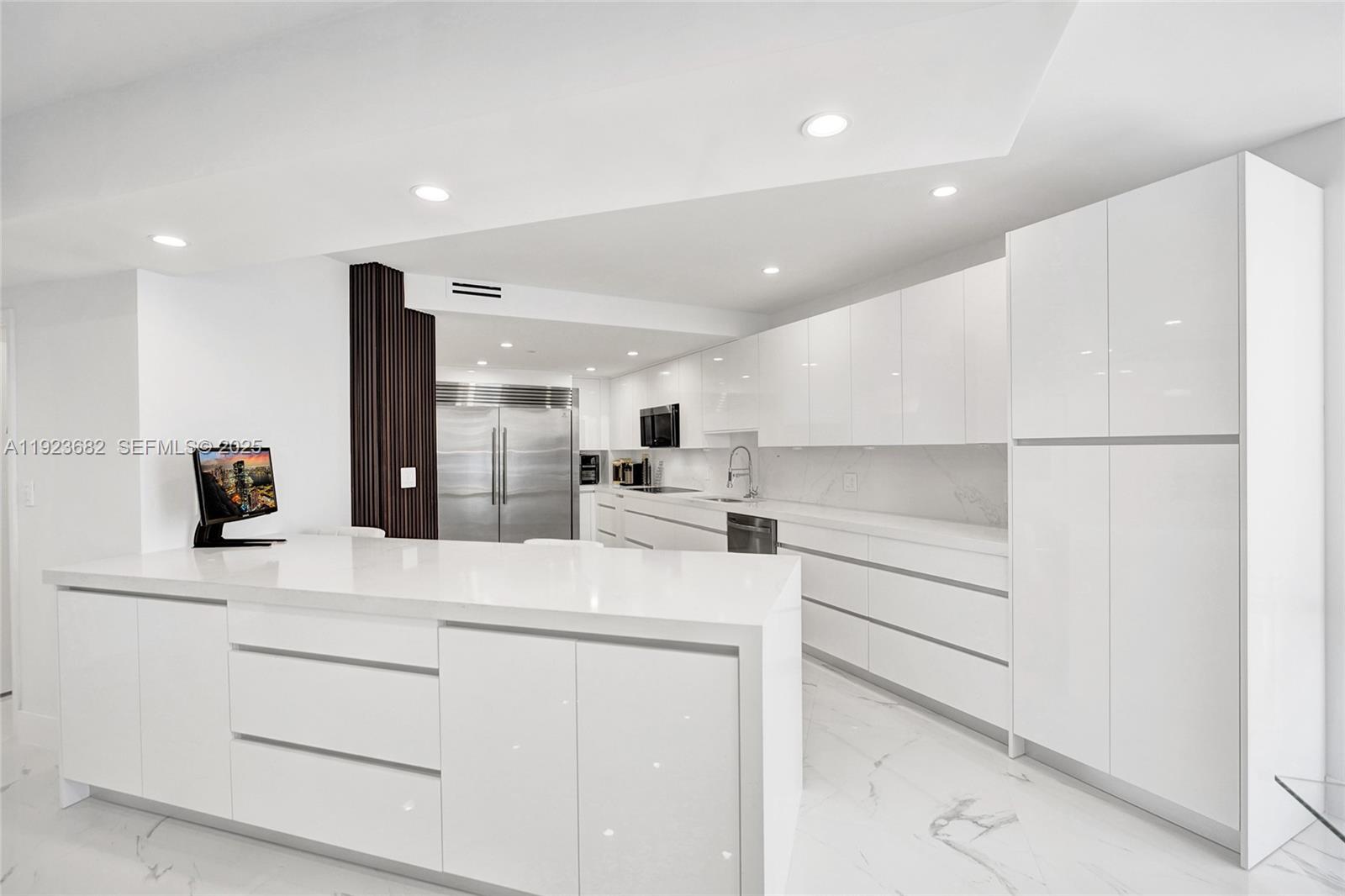 a kitchen with white cabinets and refrigerator
