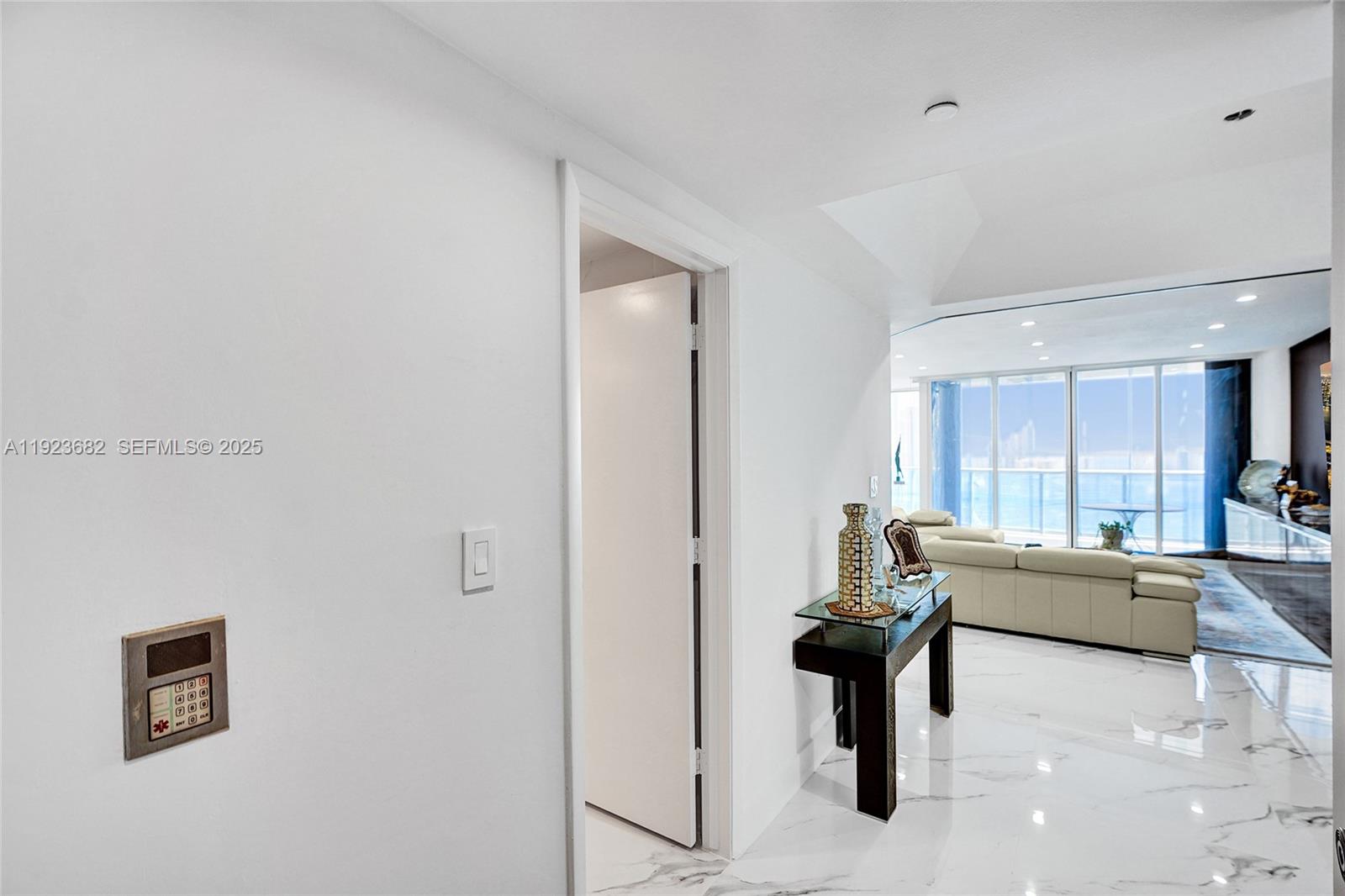 4000 Island Boulevard, Unit 2301 Aventura, FL 33160 - Photo 12 of 50 a living room with furniture and a refrigerator