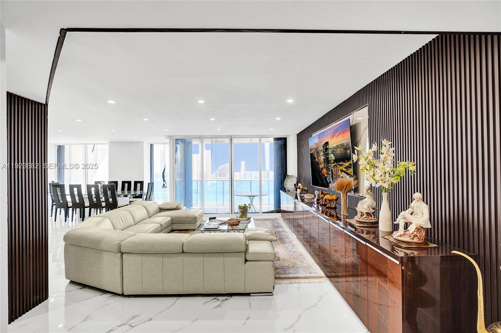 4000 Island Boulevard, Unit 2301 Aventura, FL 33160 - Photo 15 of 50 a living room with furniture and a flat screen tv