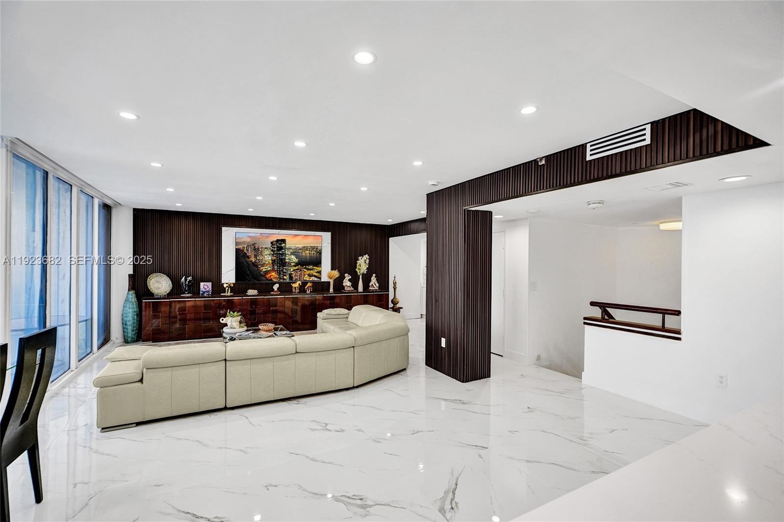 4000 Island Boulevard, Unit 2301 Aventura, FL 33160 - Photo 18 of 50 a living room with furniture and a large window