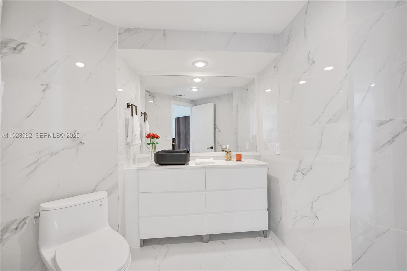 4000 Island Boulevard, Unit 2301 Aventura, FL 33160 - Photo 27 of 50 a white kitchen with a toilet sink and a refrigerator