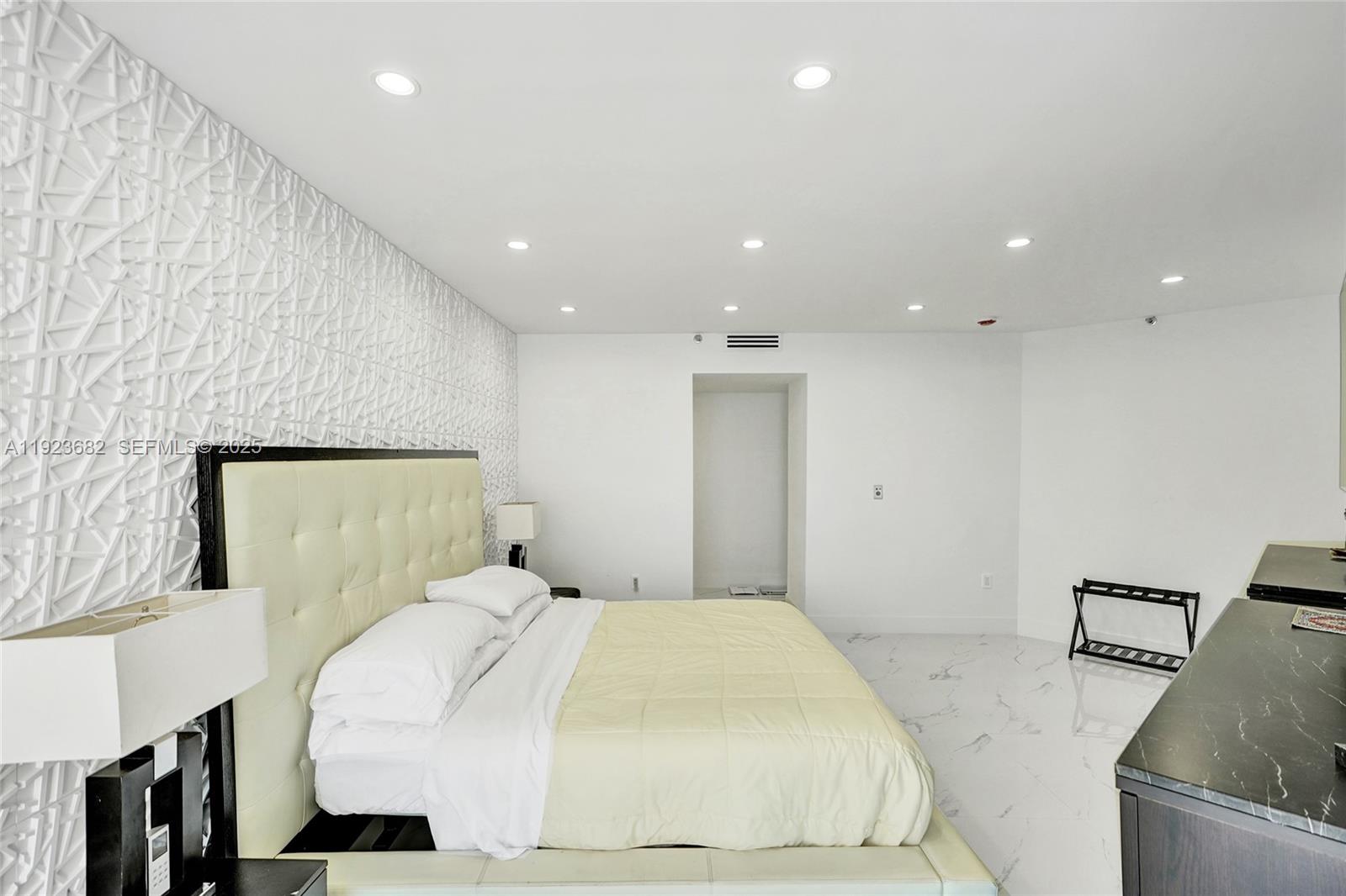 4000 Island Boulevard, Unit 2301 Aventura, FL 33160 - Photo 34 of 50 a bedroom with a bed and a couch