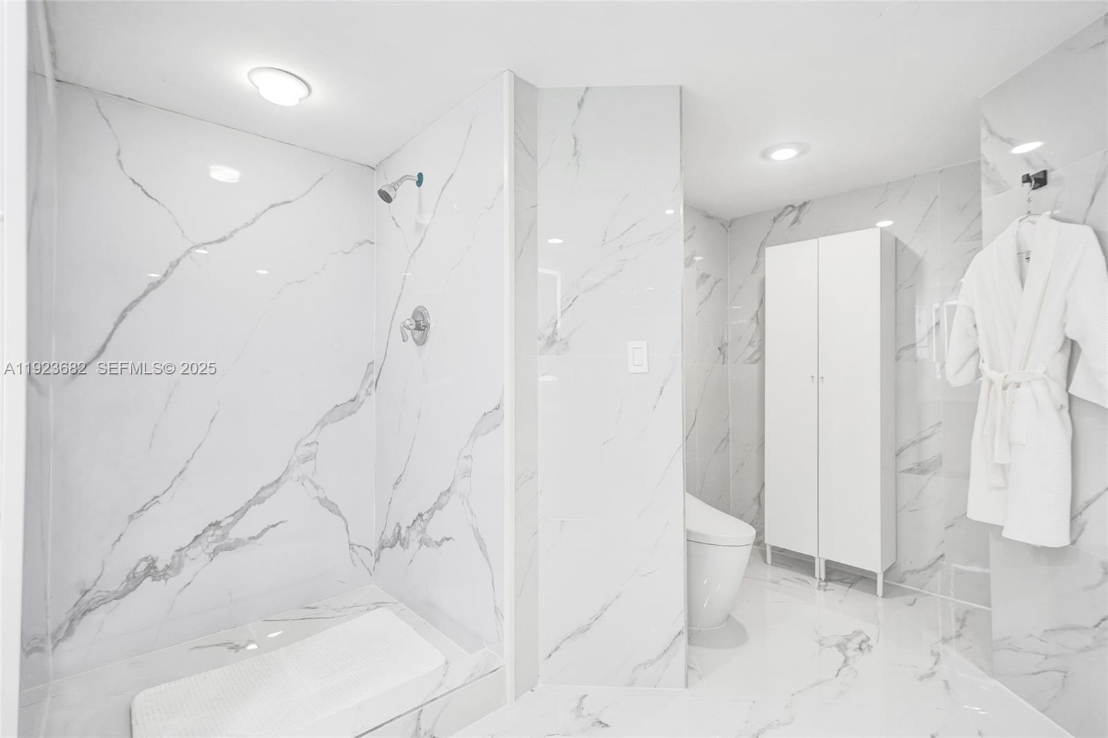 4000 Island Boulevard, Unit 2301 Aventura, FL 33160 - Photo 35 of 50 a bathroom with a shower and a tub