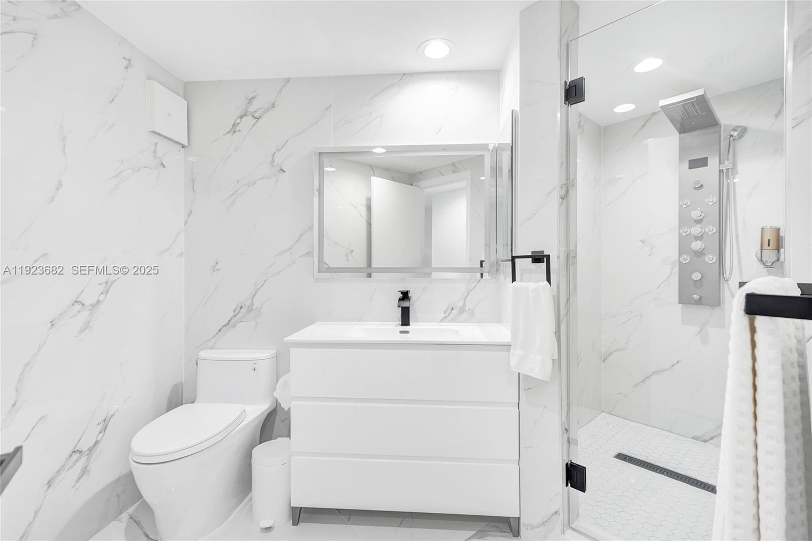 4000 Island Boulevard, Unit 2301 Aventura, FL 33160 - Photo 43 of 50 a bathroom with a sink toilet vanity and shower