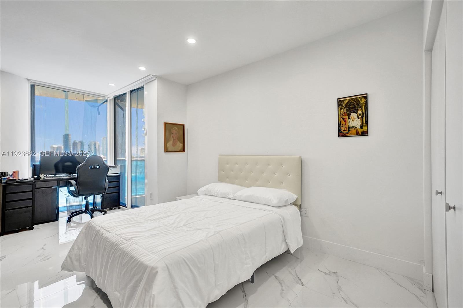 4000 Island Boulevard, Unit 2301 Aventura, FL 33160 - Photo 46 of 50 a bedroom with a bed and wooden floor