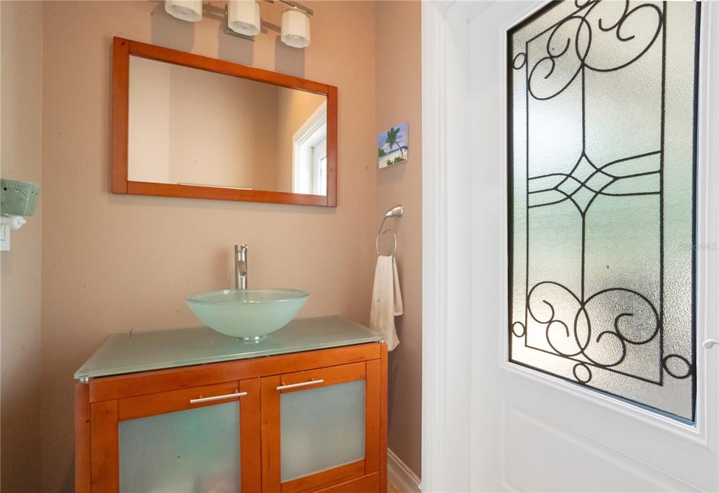 5785 Gilliam Road Orlando, FL 32818 - Photo 48 of 100 a bathroom with a sink and a mirror