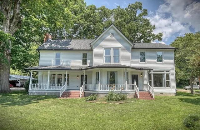 a front view of a house with a garden
