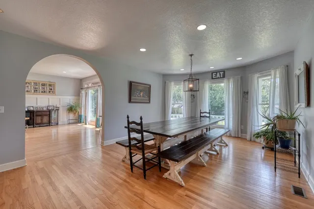 a living room with fireplace furniture and a wooden floor