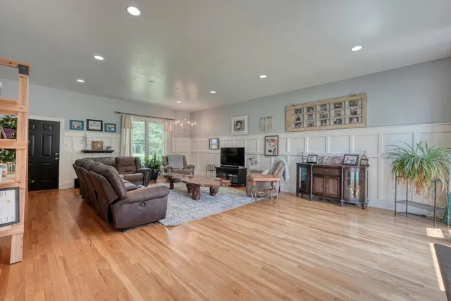 a living room with furniture and wooden floor