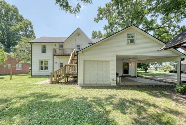 a view of a house with a yard and sitting area