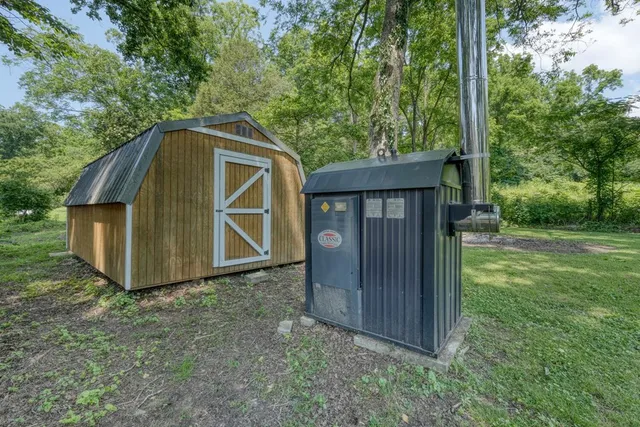 a view of a house with roof deck and furniture