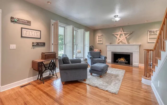 a living room with furniture and a fireplace