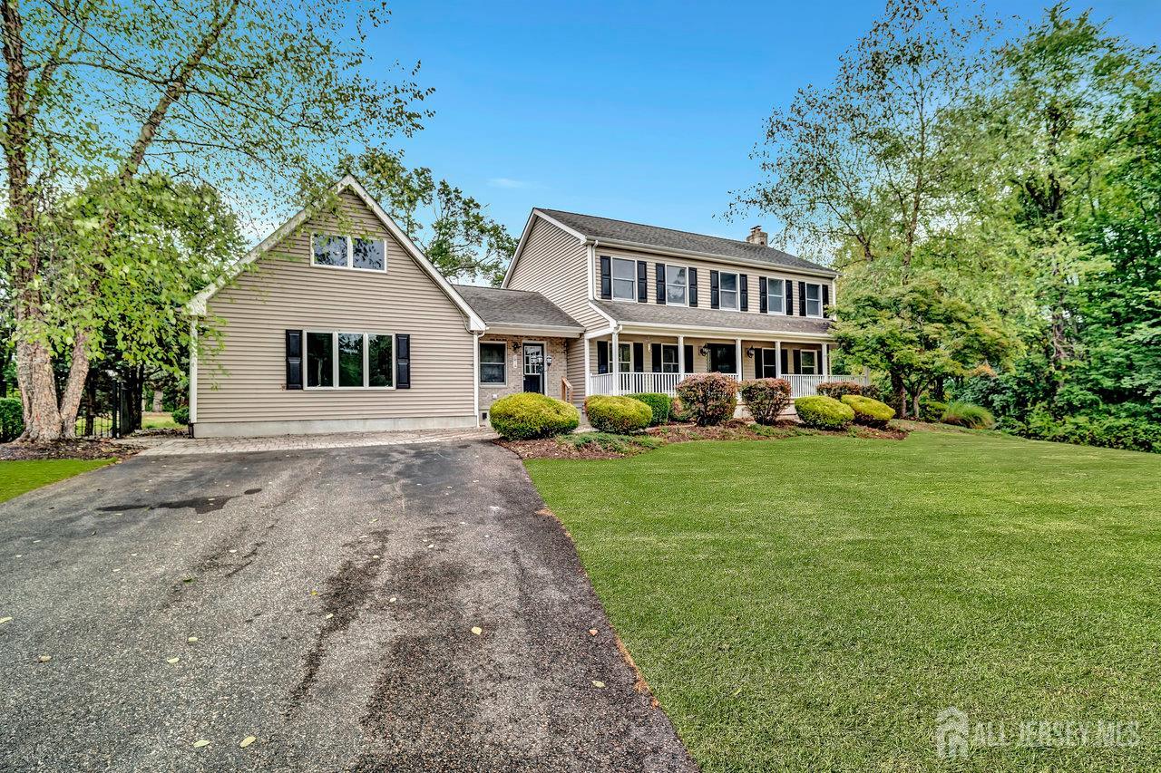 526 County Road, Unit 579 Ringoes, NJ 08551 - Photo 16 of 51 a front view of a house with a garden and trees