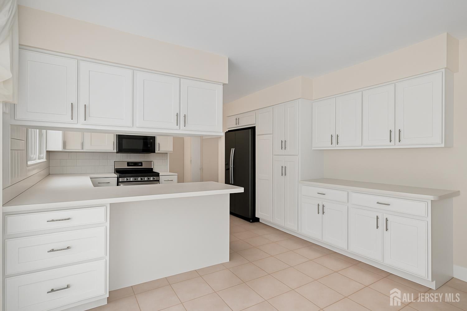 526 County Road, Unit 579 Ringoes, NJ 08551 - Photo 38 of 51 a kitchen with cabinets stainless steel appliances and a counter space