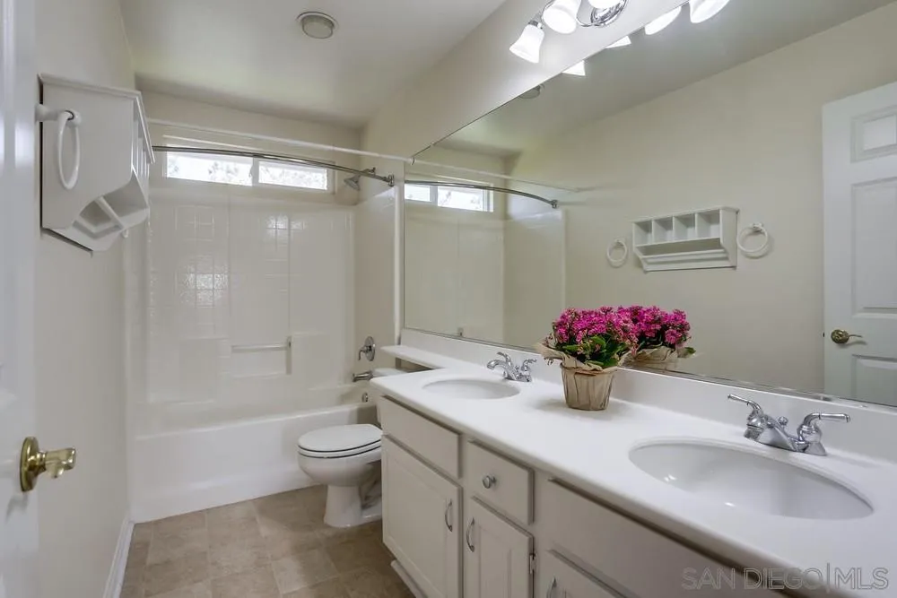 710 Greyfield Court Fallbrook, CA 92028 - Photo 23 of 28 a bathroom with a sink vanity mirror and toilet