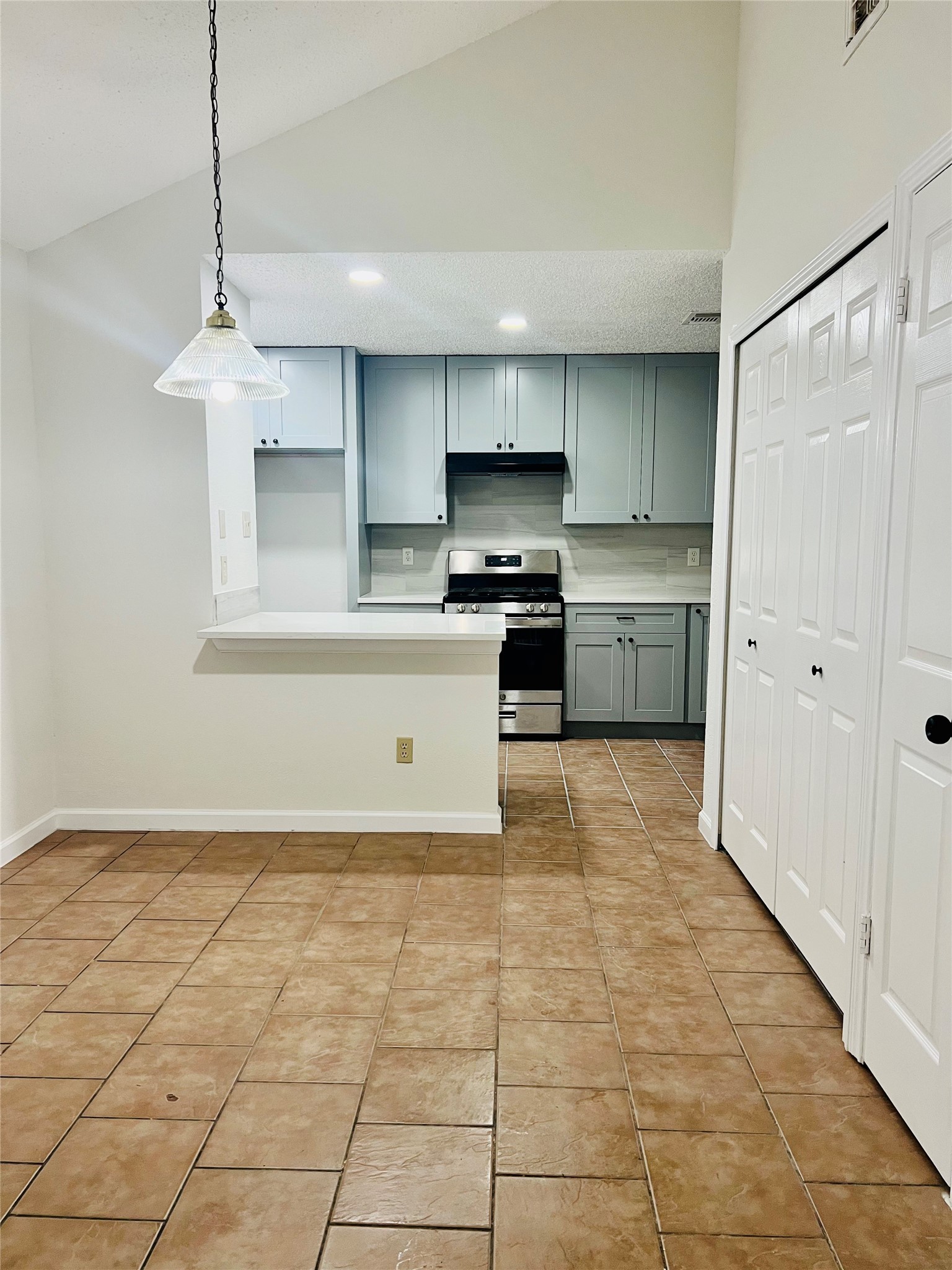 3739 Varla Lane Houston, TX 77014 - Photo 7 of 33 a kitchen with kitchen island granite countertop a stove a sink and a refrigerator
