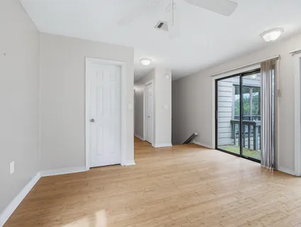 wooden floor in an empty room with a window