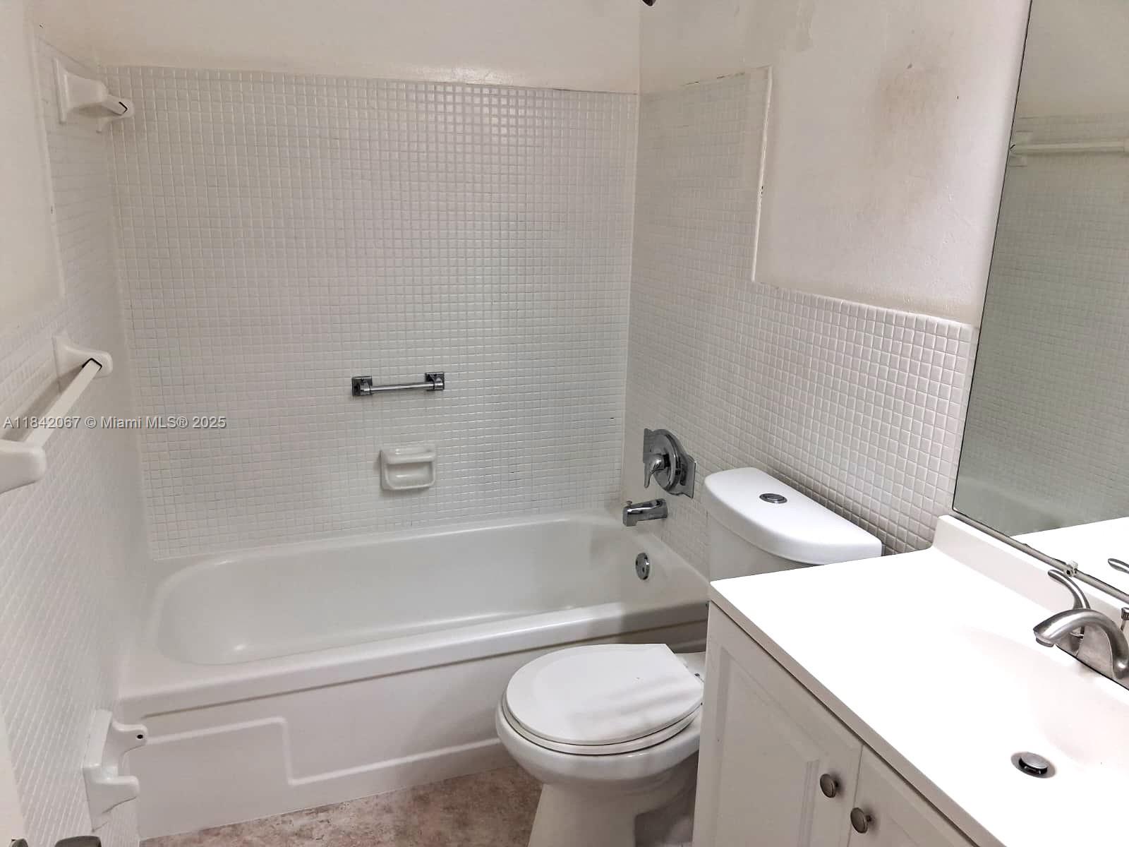 16801 Northeast 14th Avenue, Unit 209 Miami, FL 33162 - Photo 14 of 28 a bathroom with a sink toilet and bathtub