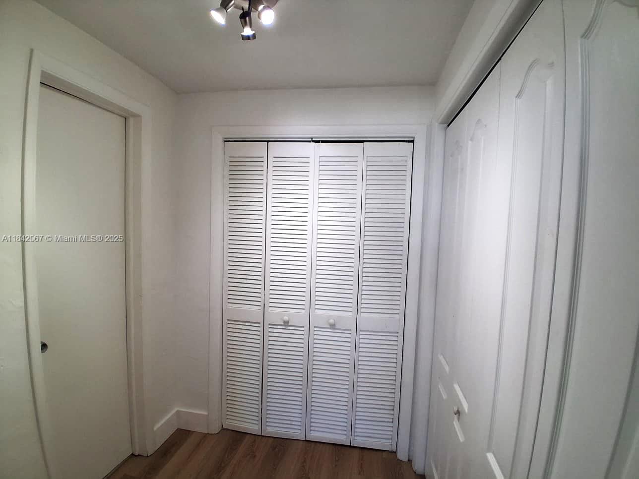 16801 Northeast 14th Avenue, Unit 209 Miami, FL 33162 - Photo 17 of 28 a view of a bathroom with wooden floor and a window