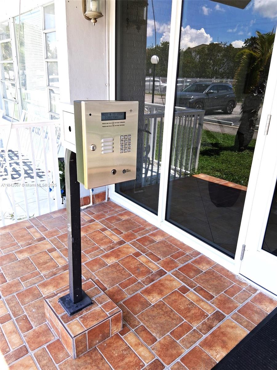 16801 Northeast 14th Avenue, Unit 209 Miami, FL 33162 - Photo 21 of 28 a view of a balcony with wooden floor and city view
