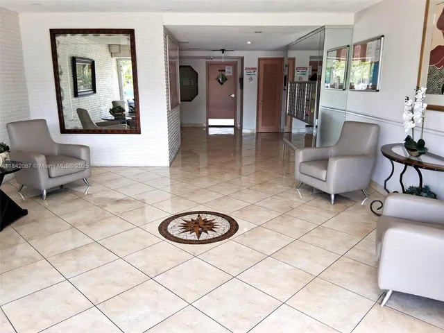 a living room with couches a coffee table and a large window with garden view