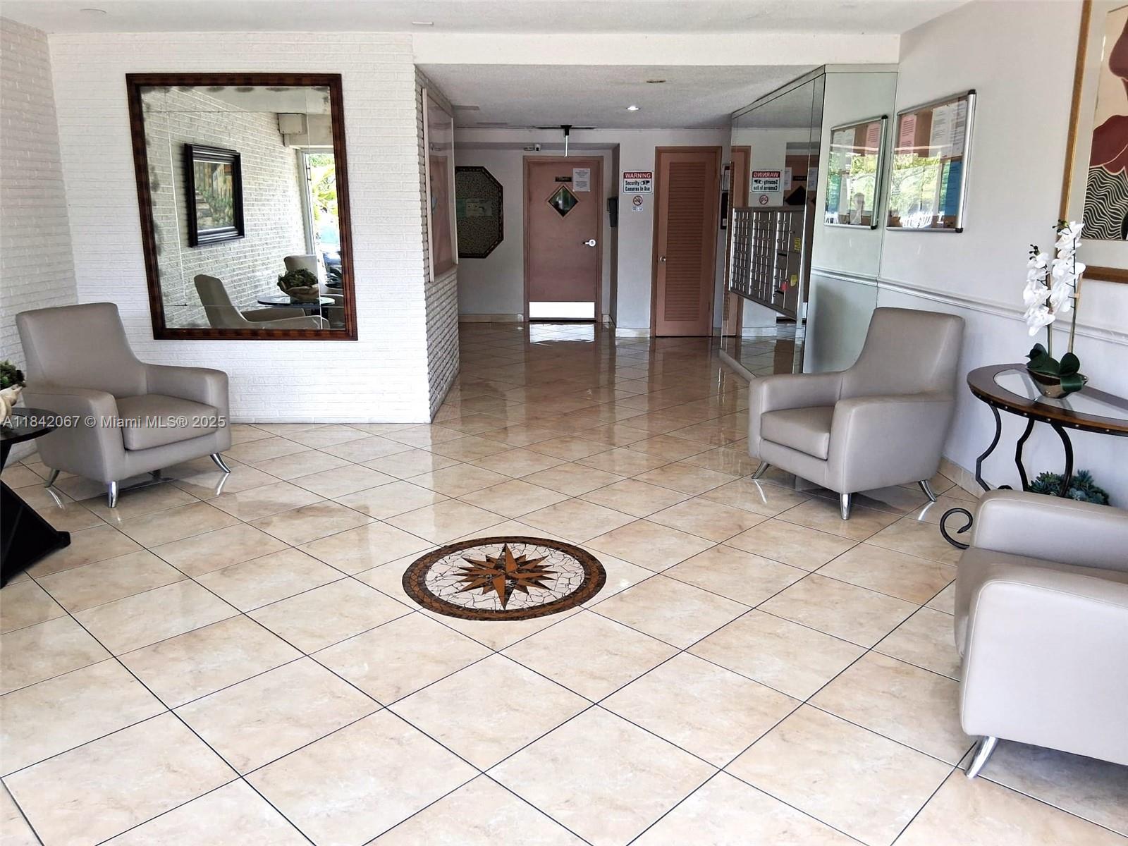 16801 Northeast 14th Avenue, Unit 209 Miami, FL 33162 - Photo 22 of 28 a living room with furniture and a couch