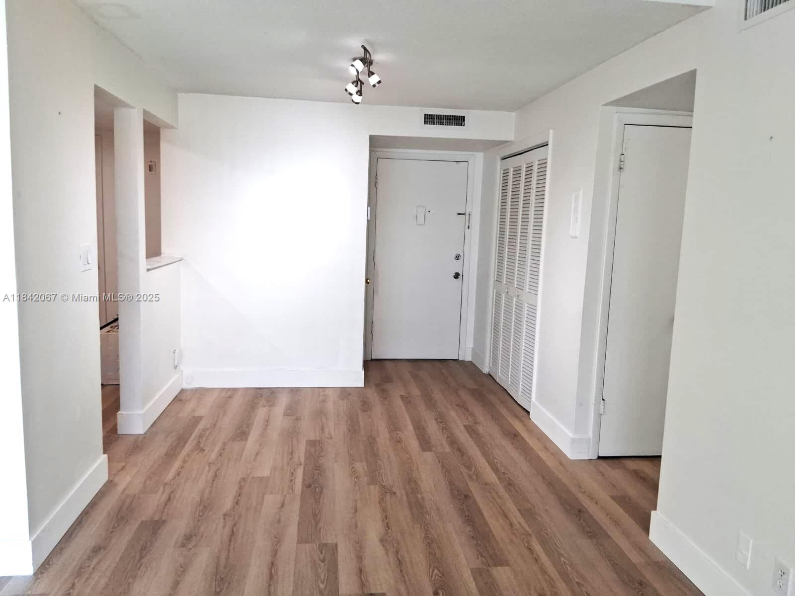 16801 Northeast 14th Avenue, Unit 209 Miami, FL 33162 - Photo 4 of 28 a view of wooden floor in an empty room