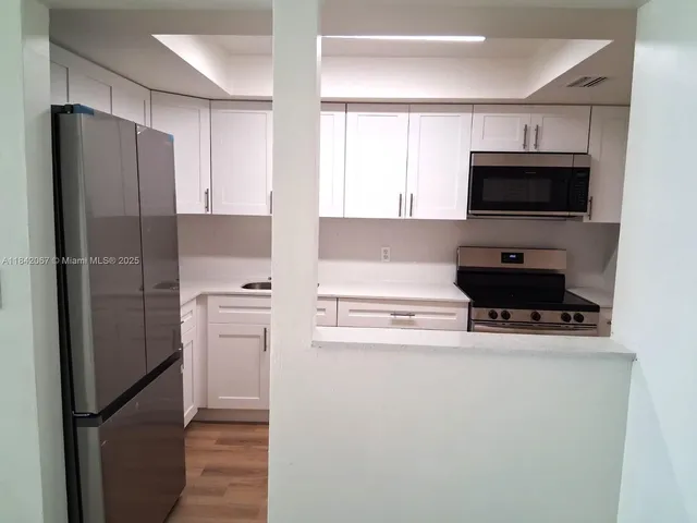 a kitchen with a sink and a microwave