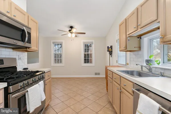 a kitchen that has a sink and a stove