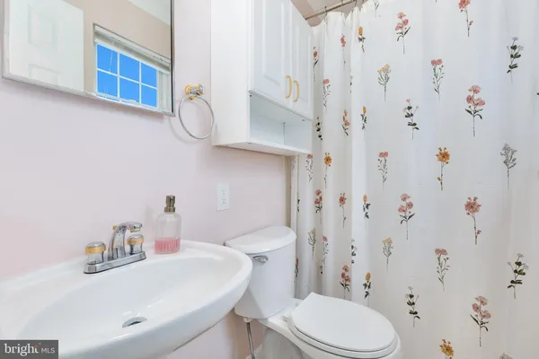 a bathroom with a sink a toilet and a mirror