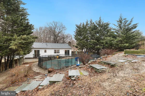 a view of a house with a yard covered with snow in the background