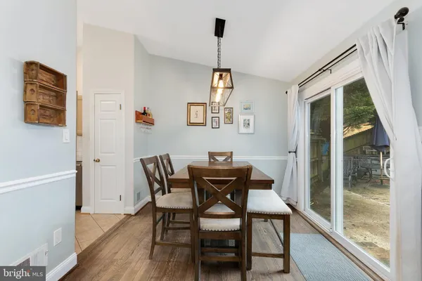 a view of a dining room with furniture and a window