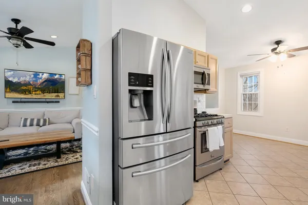 a kitchen with stainless steel appliances a refrigerator sink and stove