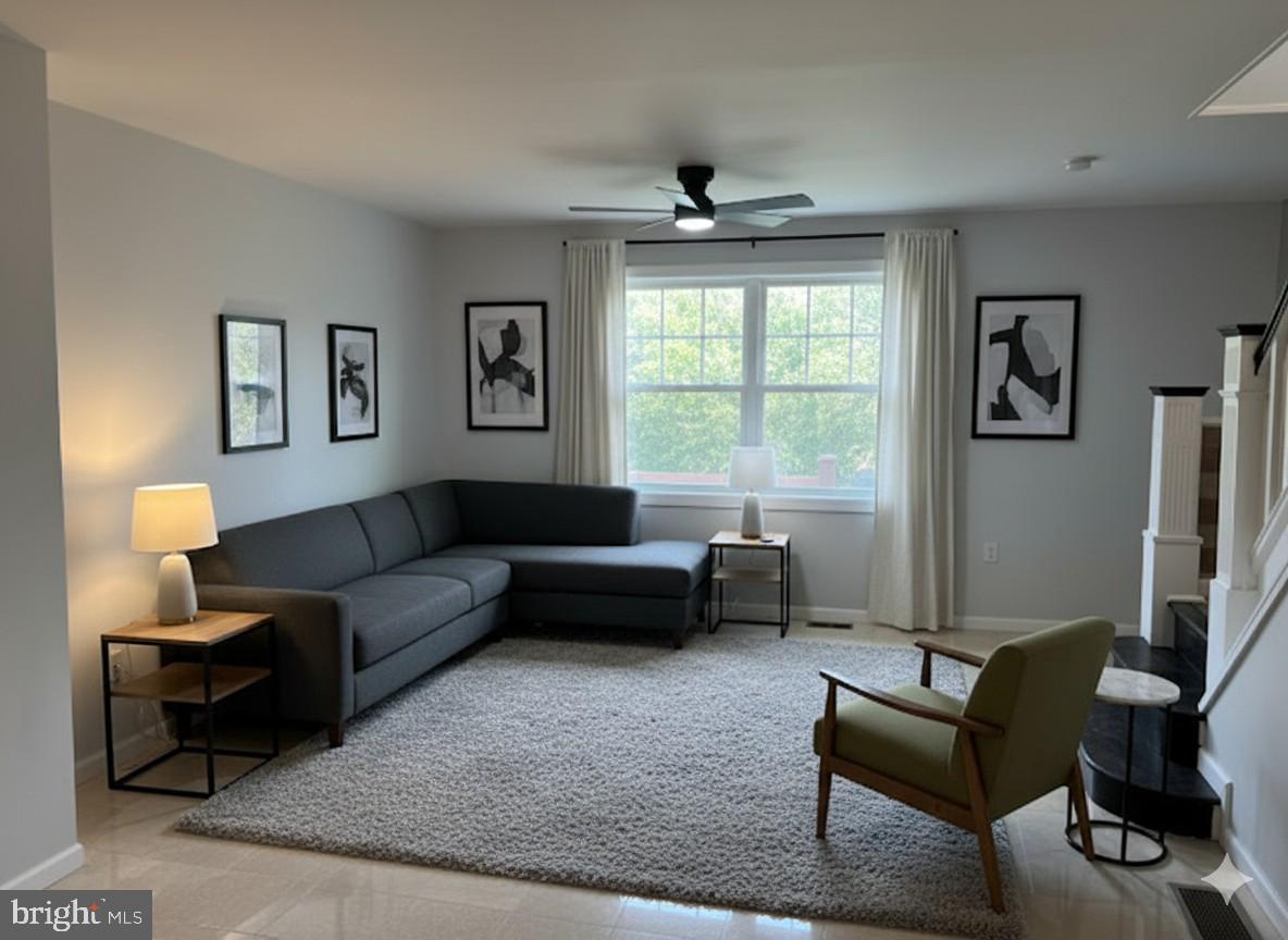 5547 Broomall Street Philadelphia, PA 19143 - Photo 16 of 17 a living room with furniture and a window