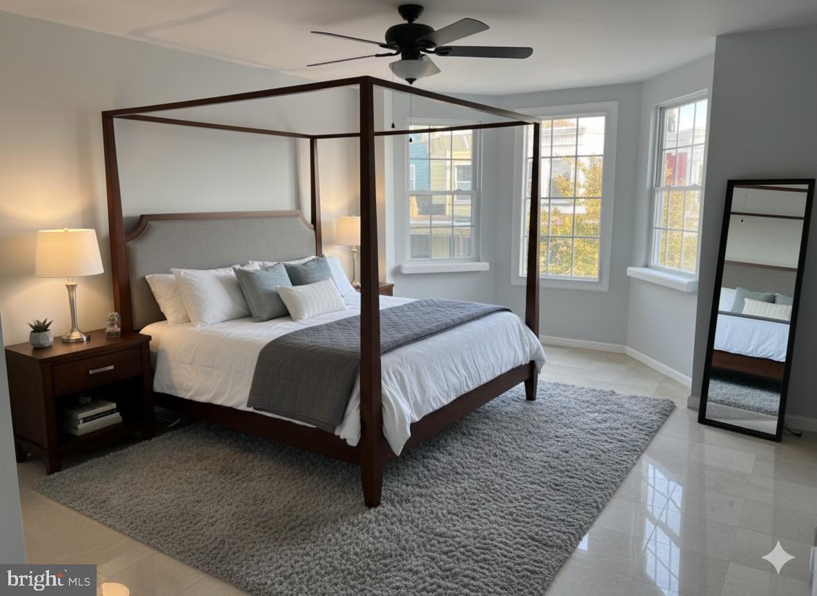 5547 Broomall Street Philadelphia, PA 19143 - Photo 17 of 17 a bedroom with a bed a mirror and a window